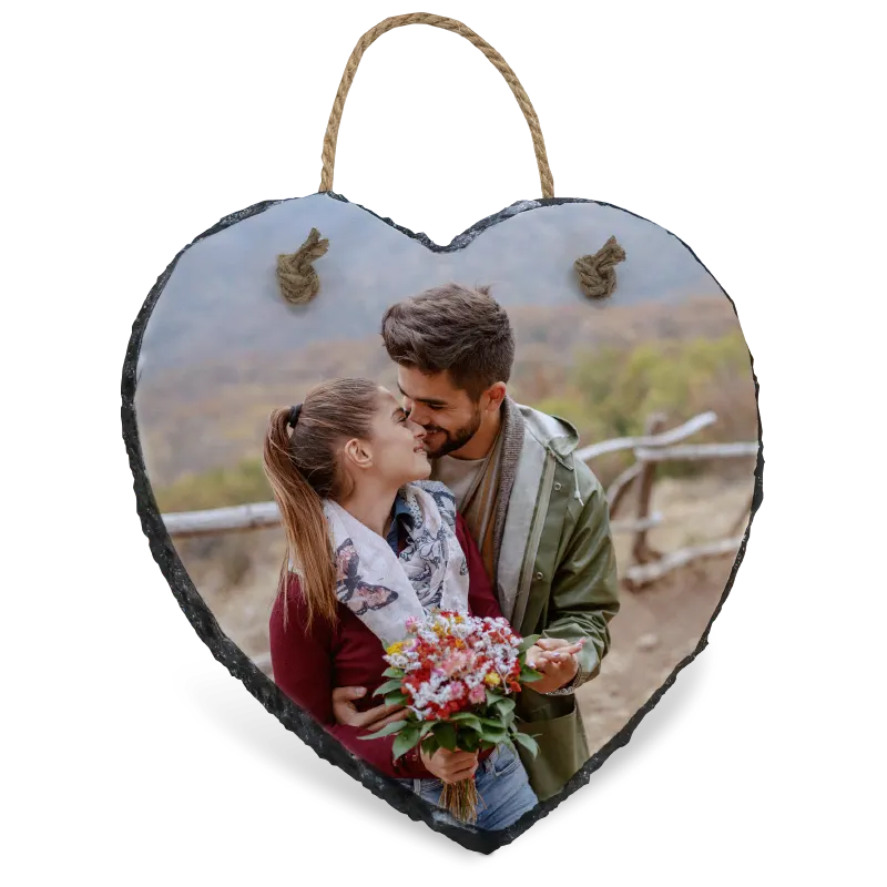 Heart-shaped slate photo plaque with a couple and flowers on a white background