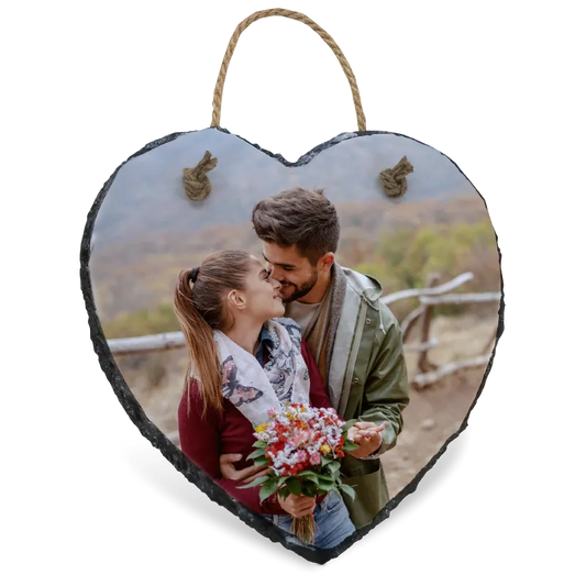 Heart-shaped slate photo plaque with a couple and flowers on a white background