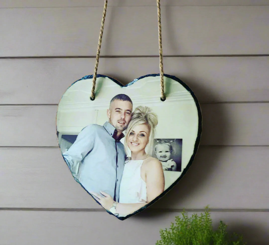 Heart-shaped wooden plaque with a couple's photo on a wooden background