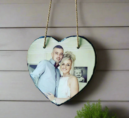 Heart-shaped wooden plaque with a couple's photo on a wooden background