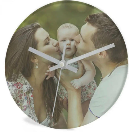 Round clock with a photo of a couple kissing a baby, set against a white background.
