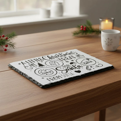 Slate with Christmas-themed text and graphics on a white background