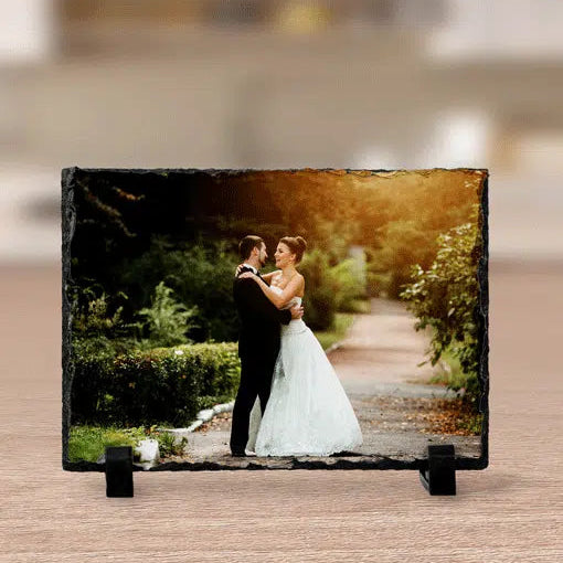 Slate with a photo of a bride and groom in a park setting