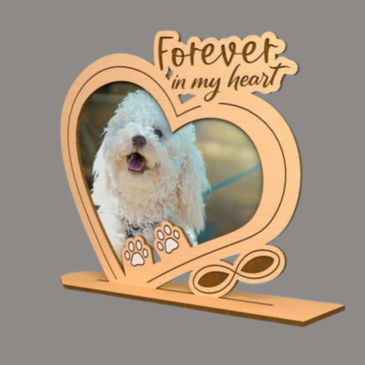 Heart-shaped wooden photo frame with a dog inside and 'Forever in my heart' text on a gray background