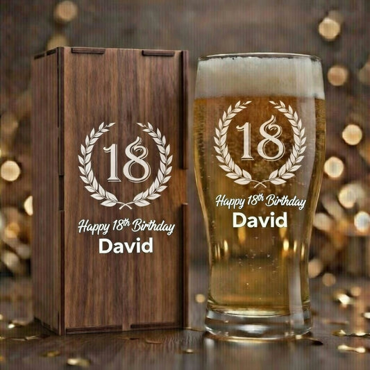 Personalized 18th birthday beer glass and wooden box with engraved text on a wooden surface.