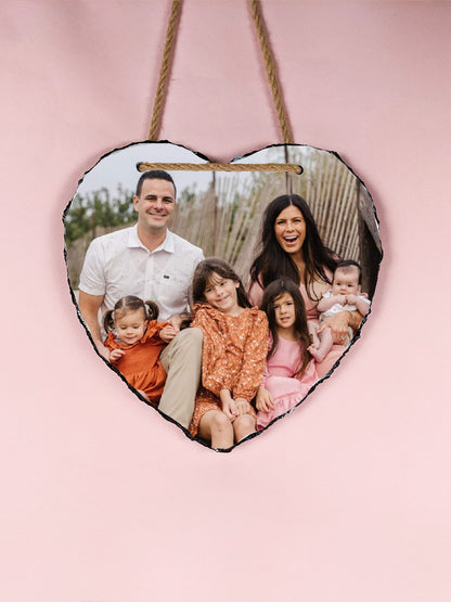 Heart-shaped photo plaque with a family picture on a pink background