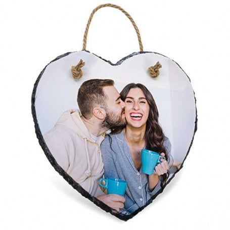 Heart-shaped photo plaque with a couple holding blue mugs on a white background