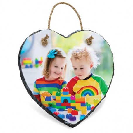 Heart-shaped photo plaque with two children playing with colorful blocks on a white background